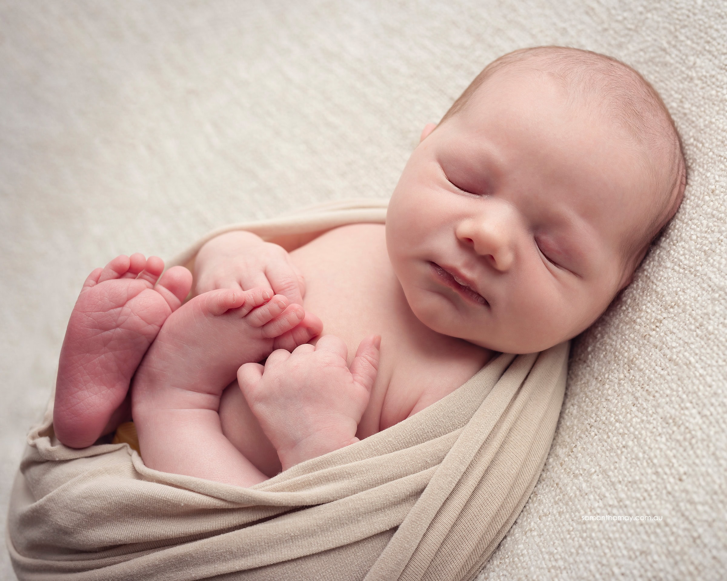 curled up newborn baby